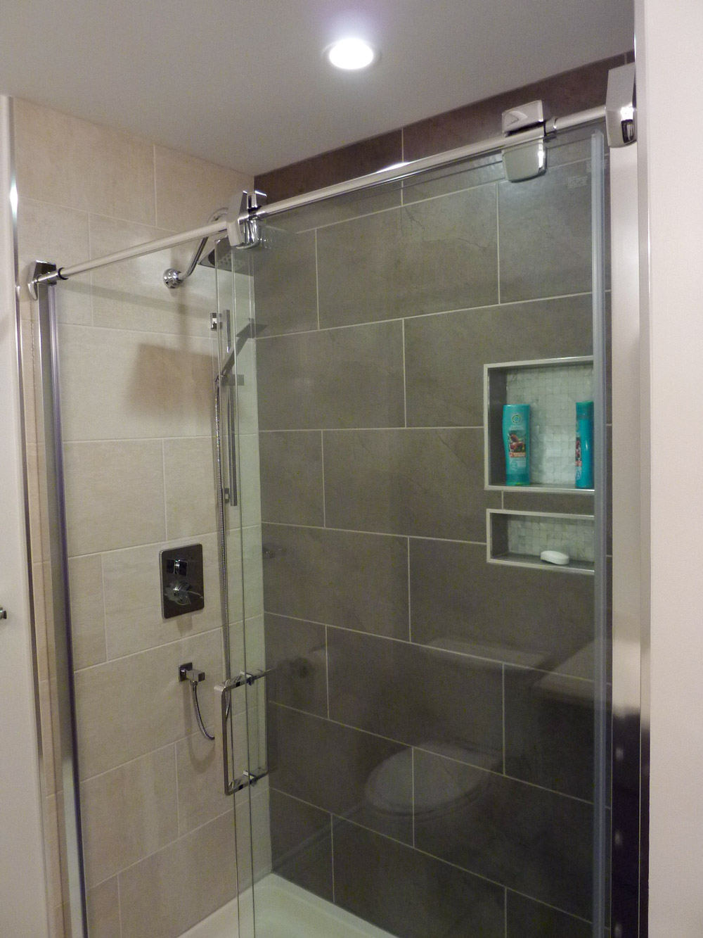 Alcove tiled shower with chrome shower door 